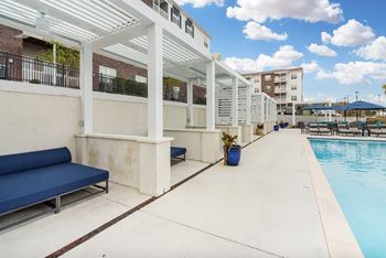 A pool area with a cabanas 