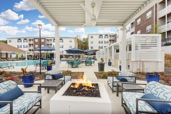A rooftop patio with tables and chairs and umbrellas
