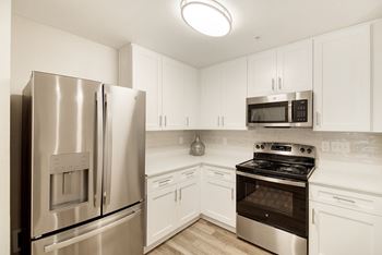 A kitchen with a stainless steel refrigerator and oven