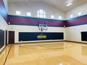 Williston apartment for rent - a basketball court in an empty gym with a basketball hoop at The Retreat Apartment Homes in Williston, ND 