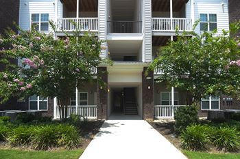 The sidewalk in front of an apartment building