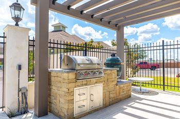 An outdoor kitchen with a grill