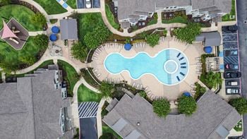 Pool with lounge chairs at kingston crossing apartment homes in bossier city la