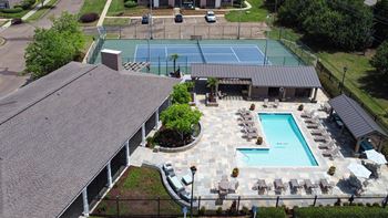 Aerial view of tennis court  by a pool