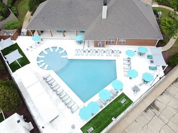 An aerial view of an apartment with a pool and a patio 