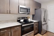 Brandon apartment for rent - a kitchen with stainless steel appliances and wooden cabinets at Bridgewater Apartment Homes, Brandon, Mississippi