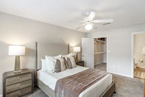 Brandon apartment for rent - a bedroom with a large bed and a ceiling fan at Bridgewater Apartment Homes, Brandon, MS 39047