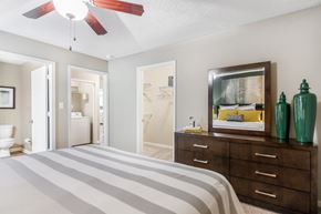 Starkville apartment for rent - a bedroom with a bed and a dresser and a bathroom at Avalon Apartments Starkville, MS, 39759