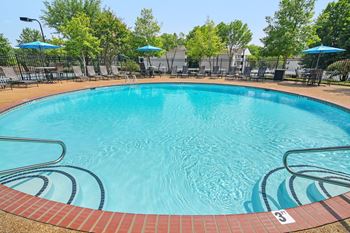 A swimming pool with a blue sky in the background
