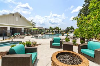 Poolside area with a fire pit and lounge chairs