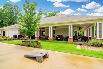 The view of a house with a patio and a lawn