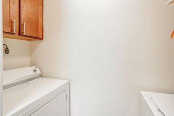 A washer and dryer in a laundry room with white walls