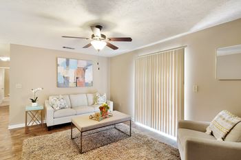 A living room with a ceiling fan and a couch