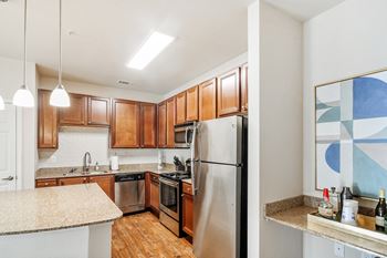 Kitchen with wooden cabinets and a stainless steel refrigerator