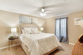 Bedroom with ceiling fan and windows at parklane apartment homes in mccomb mississippi