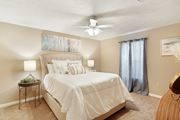 Mccomb apartment for rent - a bedroom with a large bed and a ceiling fan at Parklane Apartment Homes, Mississippi, 39648