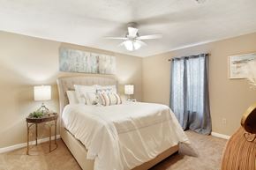 Mccomb apartment for rent - a bedroom with a large bed and a ceiling fan at Parklane Apartment Homes, Mississippi, 39648