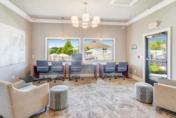 A conference room with a view of a residential area outside the window