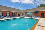 Bossier City apartment for rent - A pool with a fountain in the middle of it at Landing at Willow Bayou Apartment Homes, Bossier City, LA