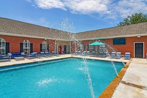 Bossier City apartment for rent - A pool with a fountain in the middle of it at Landing at Willow Bayou Apartment Homes, Bossier City, LA