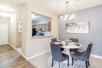 A dining room with a table set for four 