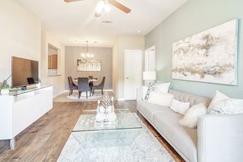 Living room with a white couch and a glass coffee table 