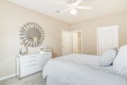 Olive Branch apartment for rent - a white bedroom with a bed and a mirror at The Vineyard of Olive Branch Apartment Homes, Olive Branch, MS, 38654