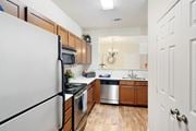 Bossier City apartment for rent - a kitchen with stainless steel appliances and wooden cabinets at Landing Willow Bayou in Bossier City, Louisiana