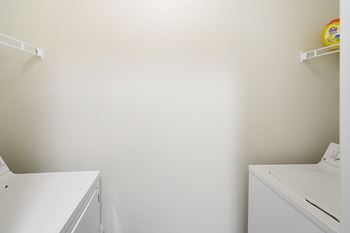 A white laundry room with a washer and dryer