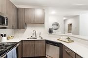 Biloxi apartment for rent - our spacious kitchen is equipped with stainless steel appliances and a white quartz counter top at Lagniappe of Biloxi Apartment Homes, Biloxi, MS