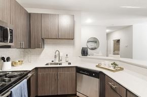 Biloxi apartment for rent - our spacious kitchen is equipped with stainless steel appliances and a white quartz counter top at Lagniappe of Biloxi Apartment Homes, Biloxi, MS