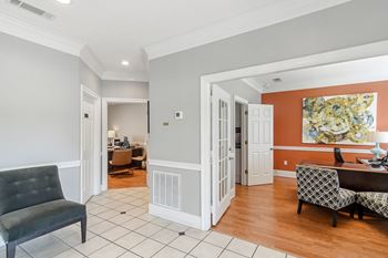 A living room and dining room with a table and chairs