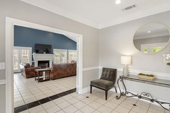 A living room with a fireplace and a mirror