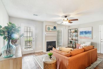 A living room with a couch and a ceiling fan