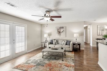 A living room with a couch and a ceiling fan