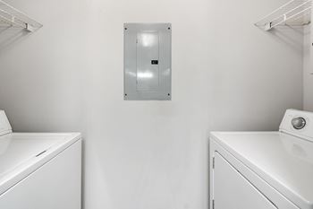 A washer and dryer in a white laundry room