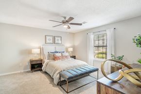 Jackson apartment for rent - a bedroom with a bed and a ceiling fan at Reserve of Jackson Apartment Homes, Mississippi, 39211