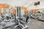 Jackson apartment for rent - a gym with cardio machines and weights on the floor and a tv at Reserve of Jackson Apartment Homes, Jackson, 39211