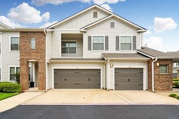 A white house with two garage doors