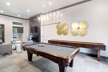 A rec room with a pool table and a tv