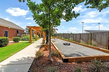 A shady area with a concrete slab and a tree in the middle 