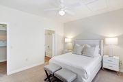 Shreveport apartment for rent - a bedroom with a large bed and a ceiling fan at Summit of Shreveport Apartments, Shreveport, Louisiana