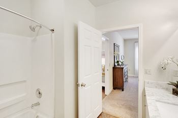 White bathroom with a walk in shower 