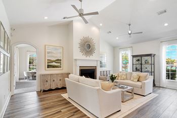 A spacious living room with a fireplace and a large painting on the wall