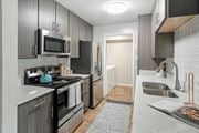 Hattiesburg apartment for rent - a kitchen with stainless steel appliances and a sink at Parkwest Apartment Homes, Hattiesburg, MS, 39402