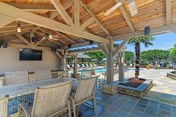 Lounge area with tv and grill