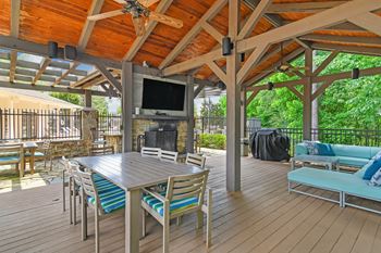 A wooden deck with a tv and seating area