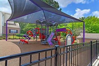 A covered playground with a slide and climbing areas