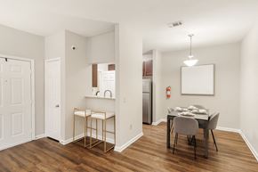 Brandon apartment for rent - Dining room and kitchen with a table and chairs at Highpointe Apartment Homes, Brandon, Mississippi