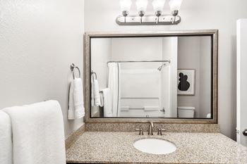 Bathroom with a sink, mirror, and towel